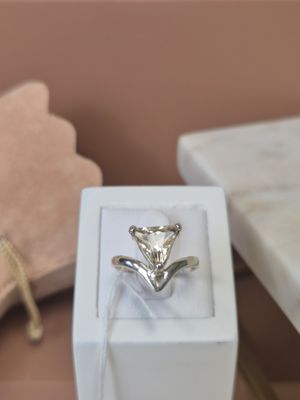 a white box with a silver ring inside of it
