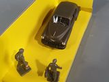 a toy car in a yellow box on a table