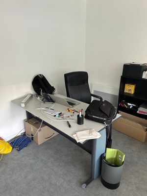 a desk with a chair and a laptop on it