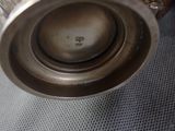 a silver vase sitting on top of a table