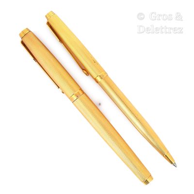 deux stylos de couleur dorée posés l'un à côté de l'autre sur une surface blanche