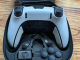 a black and white game controller in a black case
