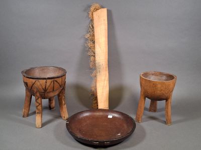 three pieces of wood are sitting on a table next to a bowl and wooden stool