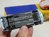 a person holding a toy car in front of a box