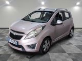 a picture of a small pink car parked in a garage