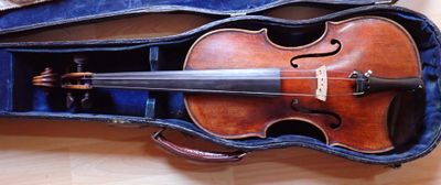 a violin that is sitting in a case on the floor