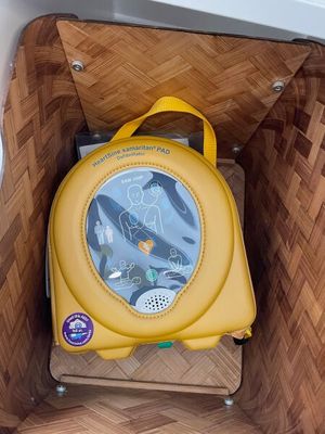 a small yellow backpack in a basket on the floor