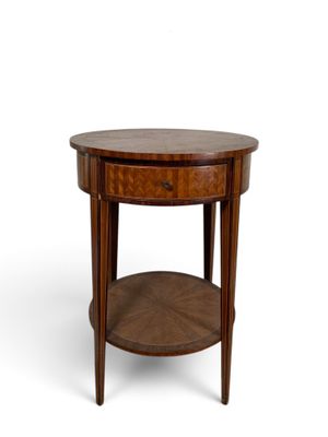 an image of a round wooden table with a drawer underneath it