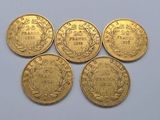 five gold coins with the names of different countries on them