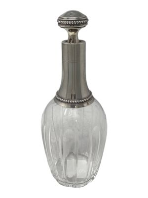 an image of a clear glass bottle with a metal stopper