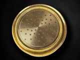 a close up of a gold coin on a black background