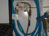a blue hose attached to a wall next to a white wall