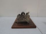 a small model of a plane on a wooden base