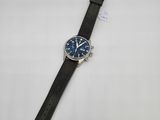 a black watch with a blue dial on a black leather strap