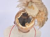 a doll that has a hair on top of it ' s head