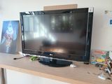 a flat screen tv sitting on top of a wooden table