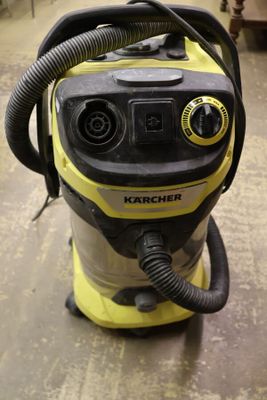 a yellow and black vacuum on the floor in a room