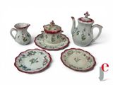 four pieces of china on a white table