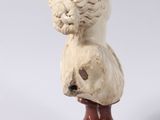 an image of a statue of a lion on top of a skull