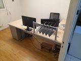 a desk with two computers and a monitor on it