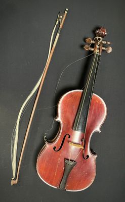 an old violin with a bow and a bow rest on a table