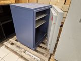 a blue safe box sitting on a pallet in a warehouse