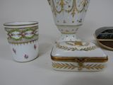 three vases and a box sitting on a table