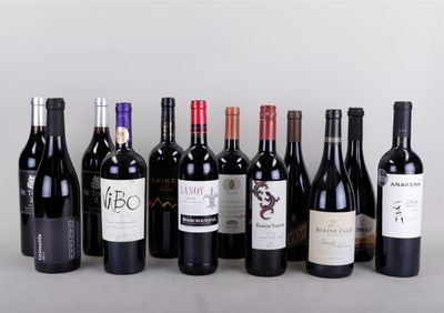 several bottles of wine are lined up on a table