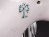a close up of a white horse with a cross on it ' s back