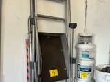 une échelle et des seaux de peinture dans un garage