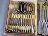 a lot of spoons and forks in a box