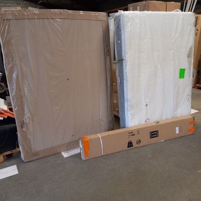 boxes of mattresses are stacked on pallets in a warehouse
