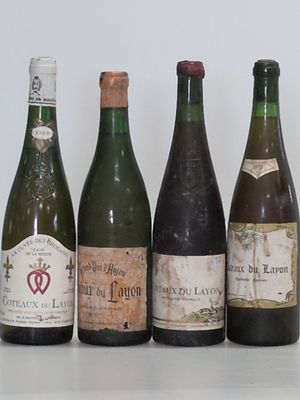 bottles of wine are lined up in a row on a table