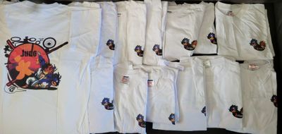 a lot of t - shirts that are sitting on a table