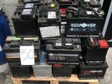 de nombreux types de batteries empilées sur une palette