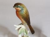 two figurines of birds sitting on top of each other