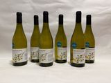 four bottles of wine are lined up on a white surface