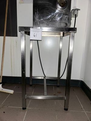 a metal table with a mop on top of it in a room