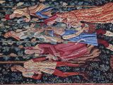 an image of a tapestry with a picture of a man and a woman on horseback