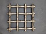 an image of a close up of a metal grate on a table