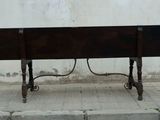 a wooden bench sitting on the side of the street
