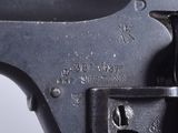 a close up of a gun on a white surface