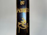 a blue book with gold writing on it sitting on a stand