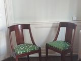 two chairs that are sitting next to each other in a room
