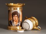 a picture of a gold and white vase with a picture of a man on it
