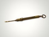 an old brass spoon with a handle on a white background