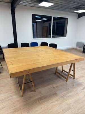an empty meeting room with a wooden table and black chairs