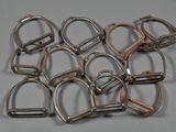a lot of metal horse bitts on a gray surface