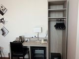 a small bedroom with a desk and a bed