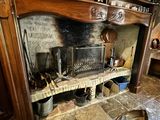 a fireplace with pots and pans on top of it